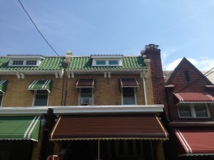 Brown aluminum awning installed at the front of a porch to give extra protection.